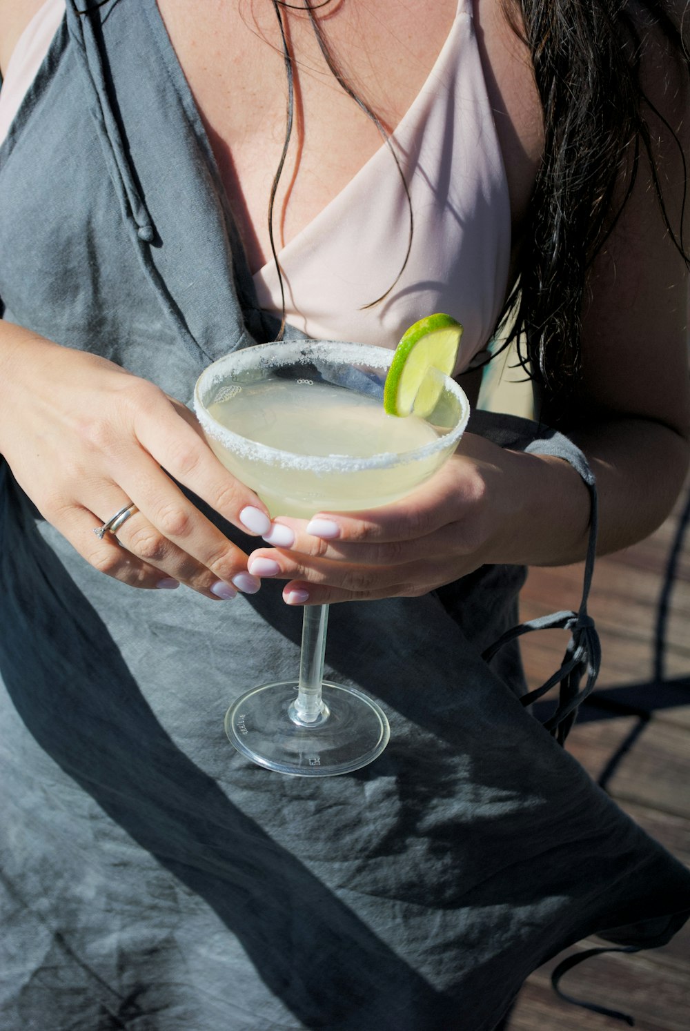 a woman holding a margarita in her hand