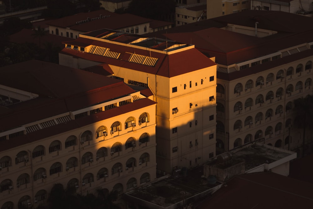 an aerial view of a building with a red roof