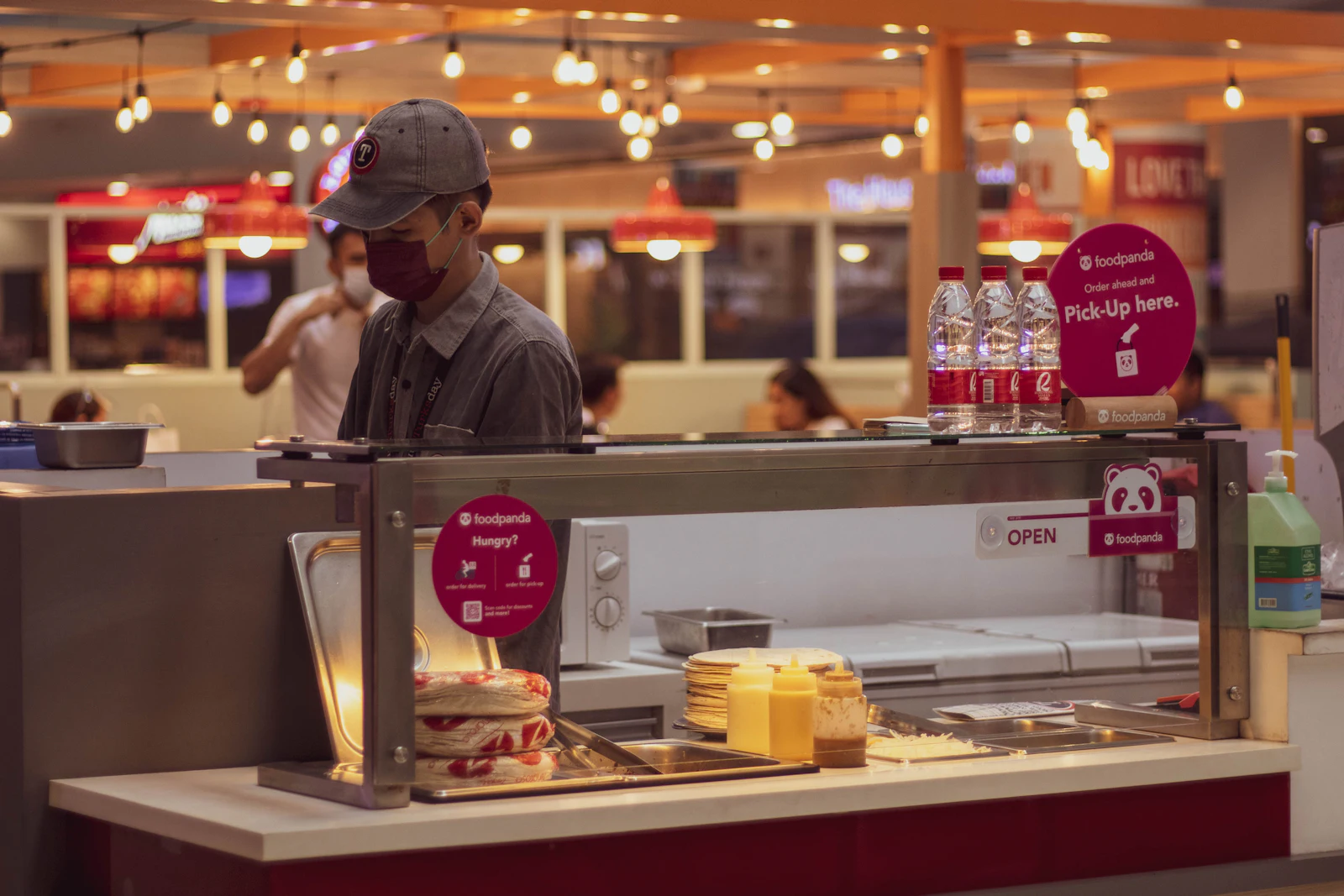 Service crew working behind a quick-service restaurant pickup counter