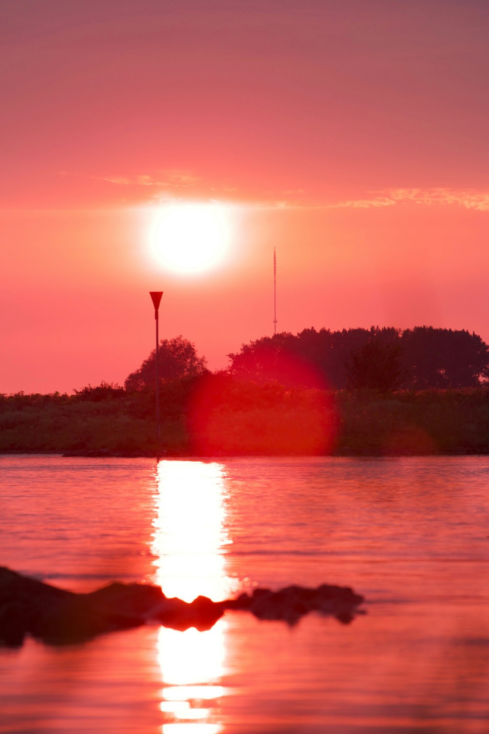 the sun is setting over a body of water