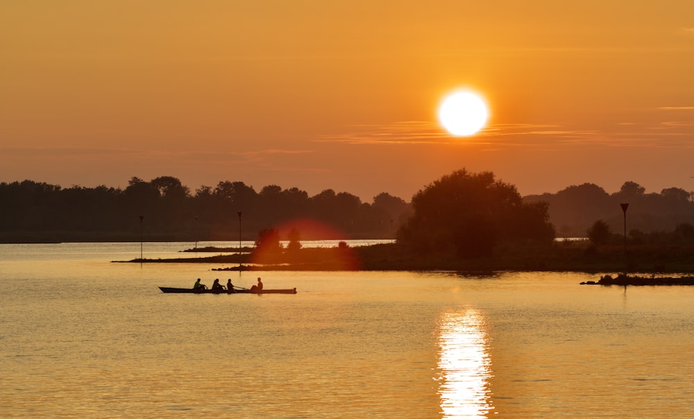 the sun is setting over a body of water