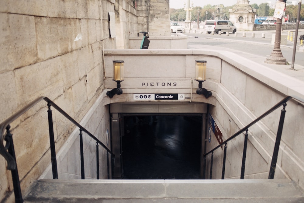 a concrete tunnel with a metal hand rail