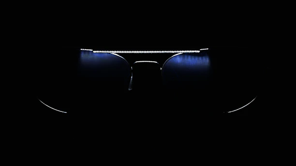 Modern eyeglass frames showcasing the photochromic lens technology in different lighting conditions.