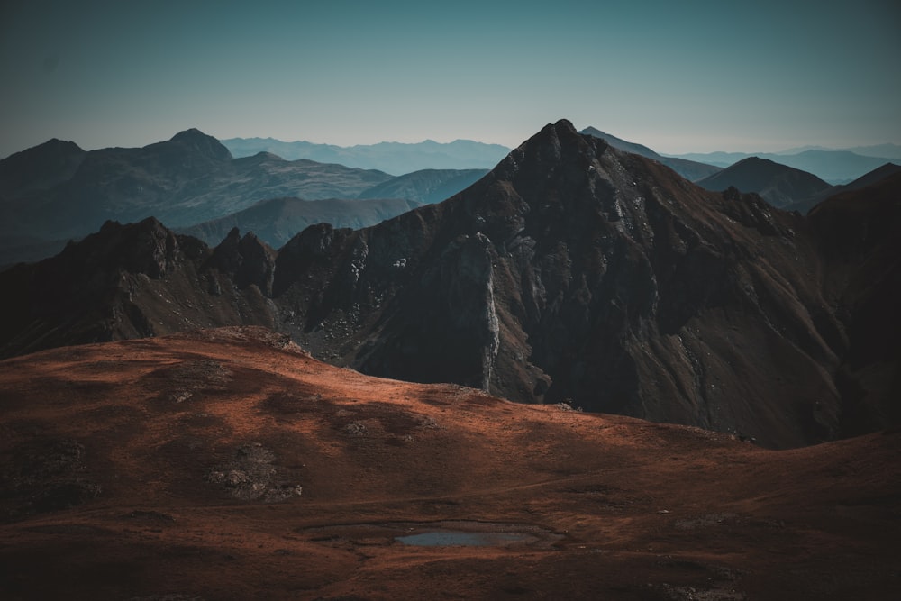 a mountain range with a lake in the foreground