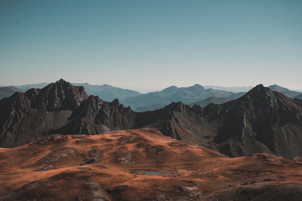 a view of a mountain range with a lake in the foreground