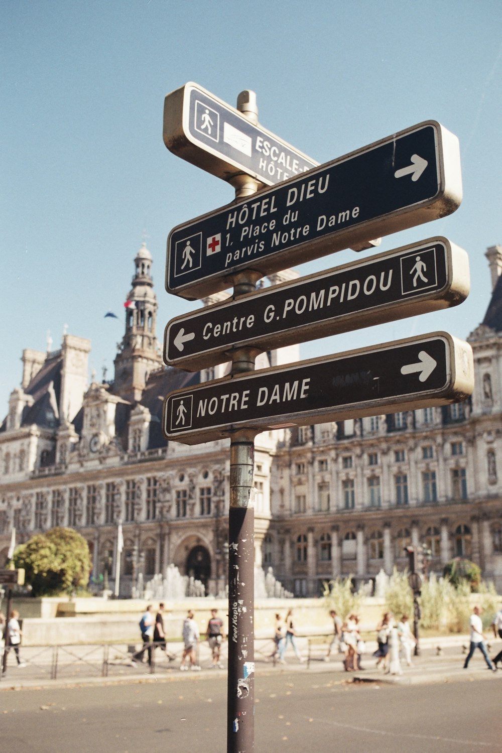 a street sign in front of a large building