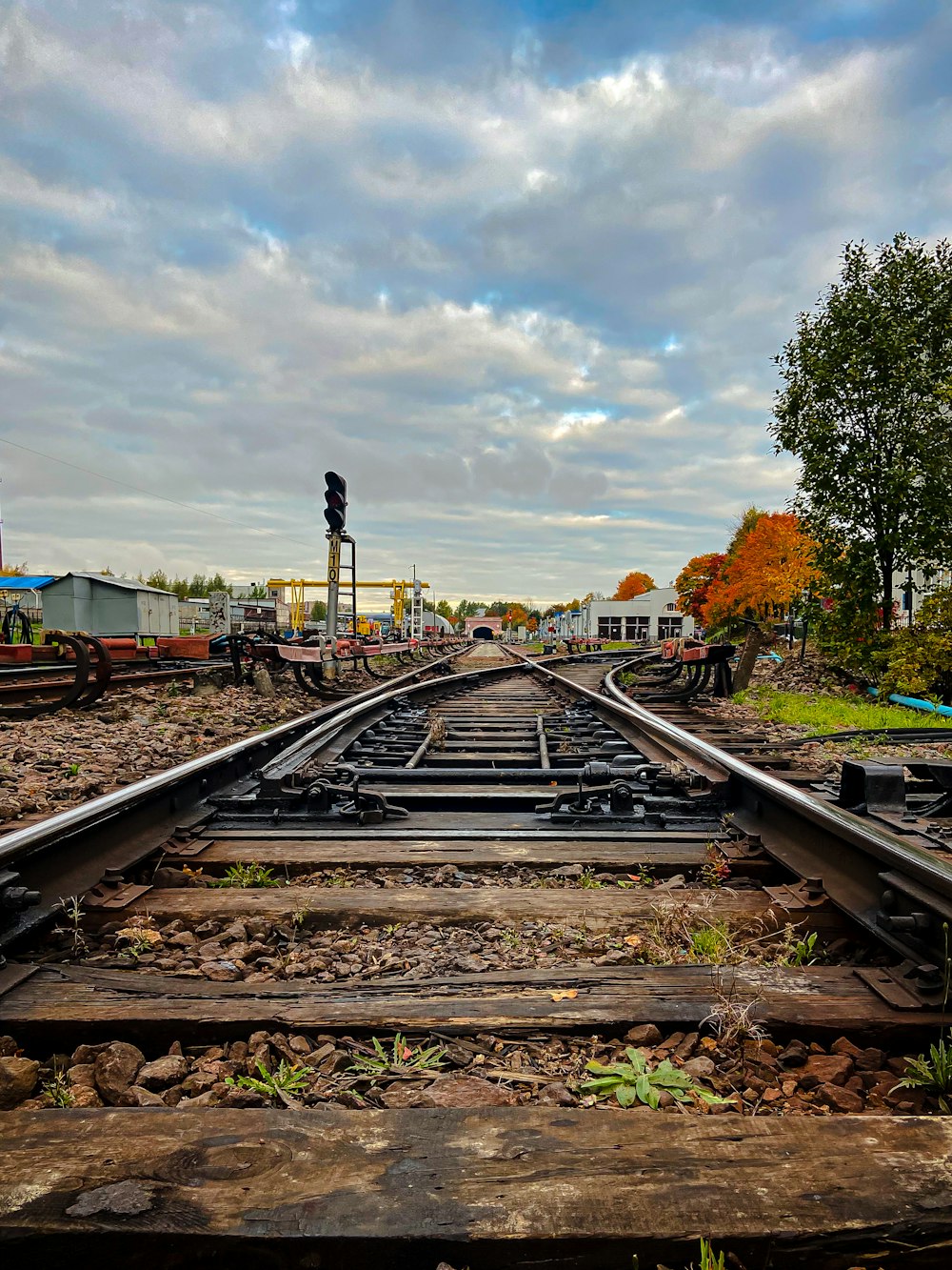 a railroad track with a traffic light on top of it