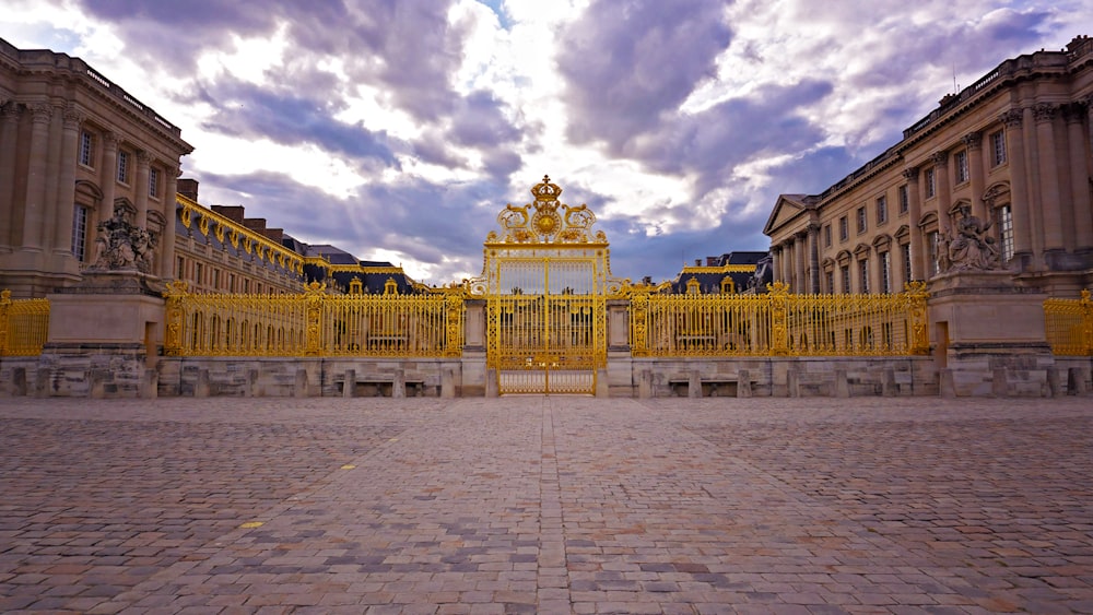 a large building with a golden gate in front of it