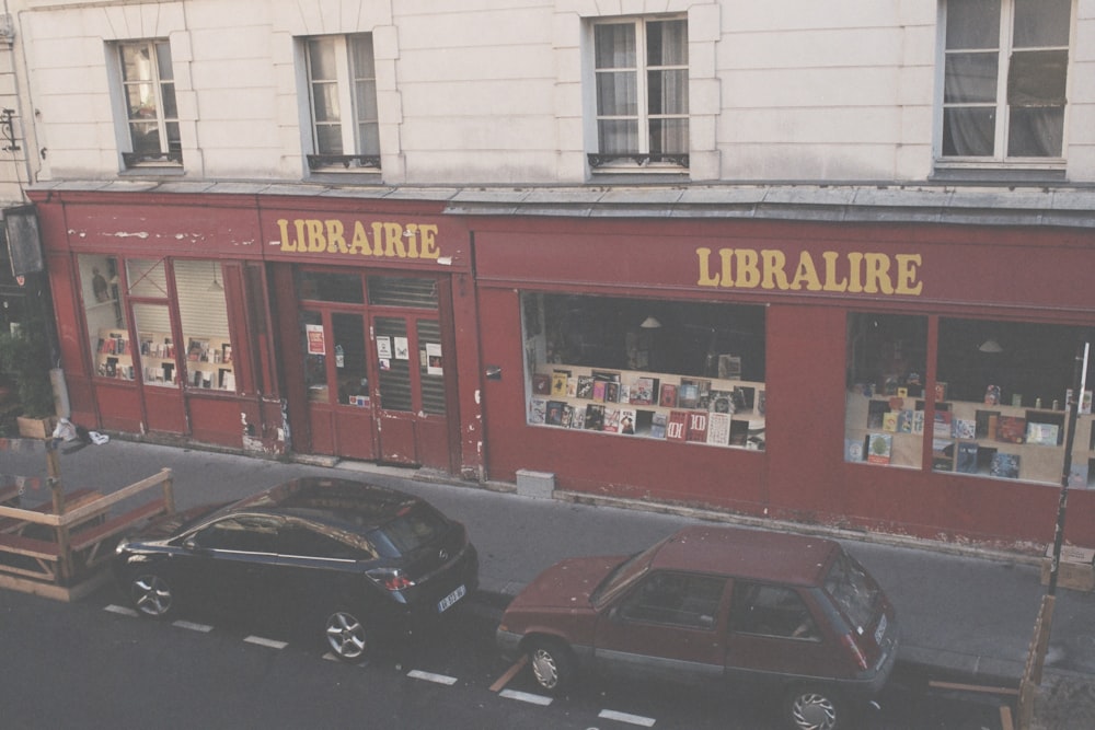 a street with cars parked in front of a library