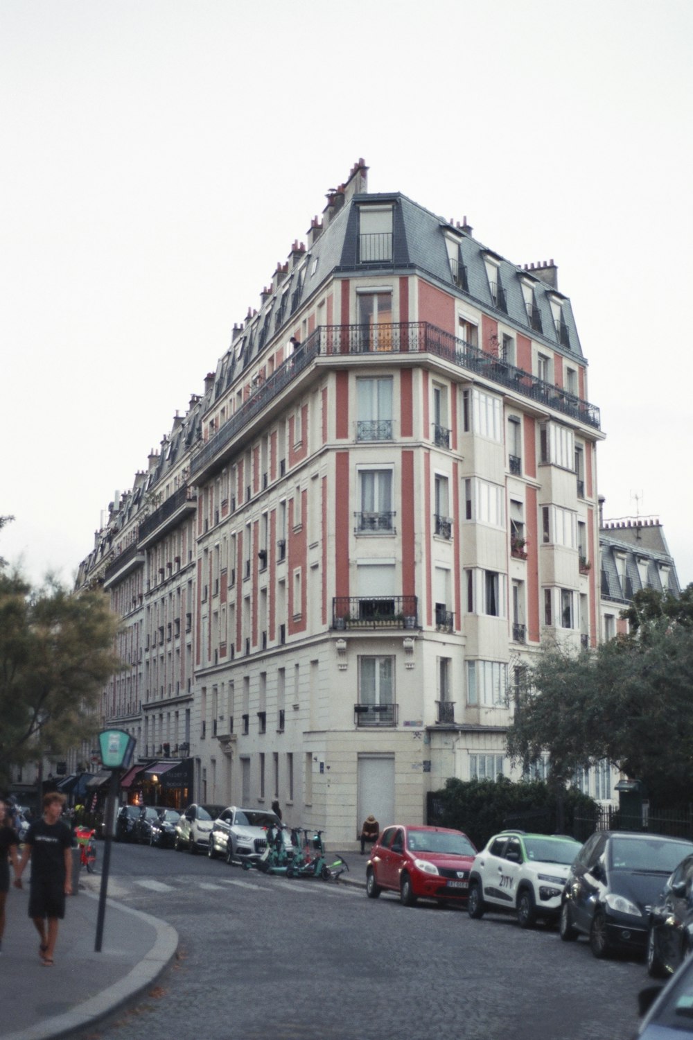 a very tall building sitting on the side of a road