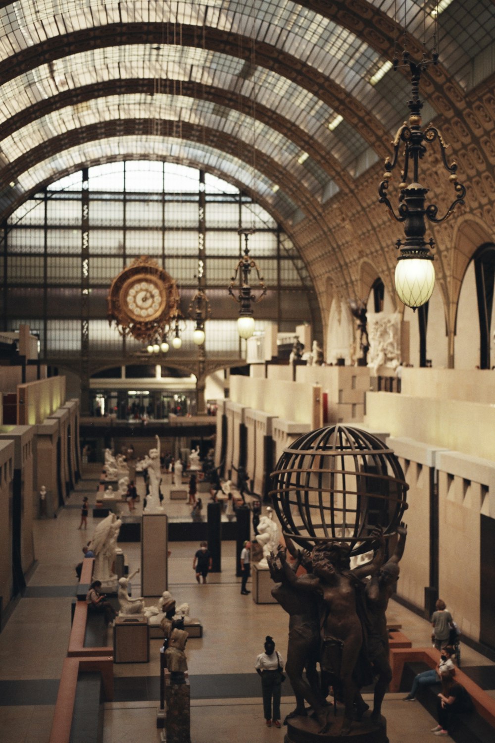 a large building with a clock and statues inside of it