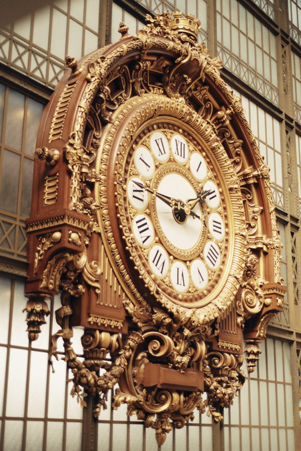 a large ornate clock hanging from the side of a building
