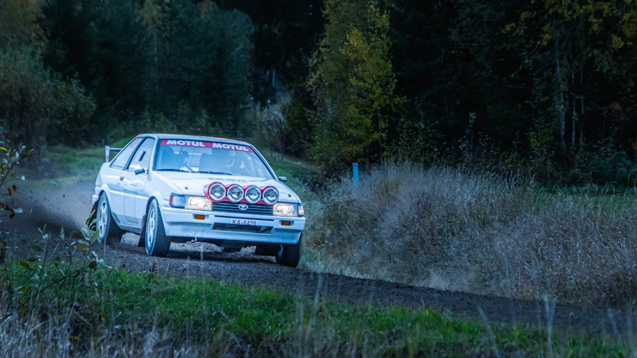 Rally car sliding on a gravel forest road