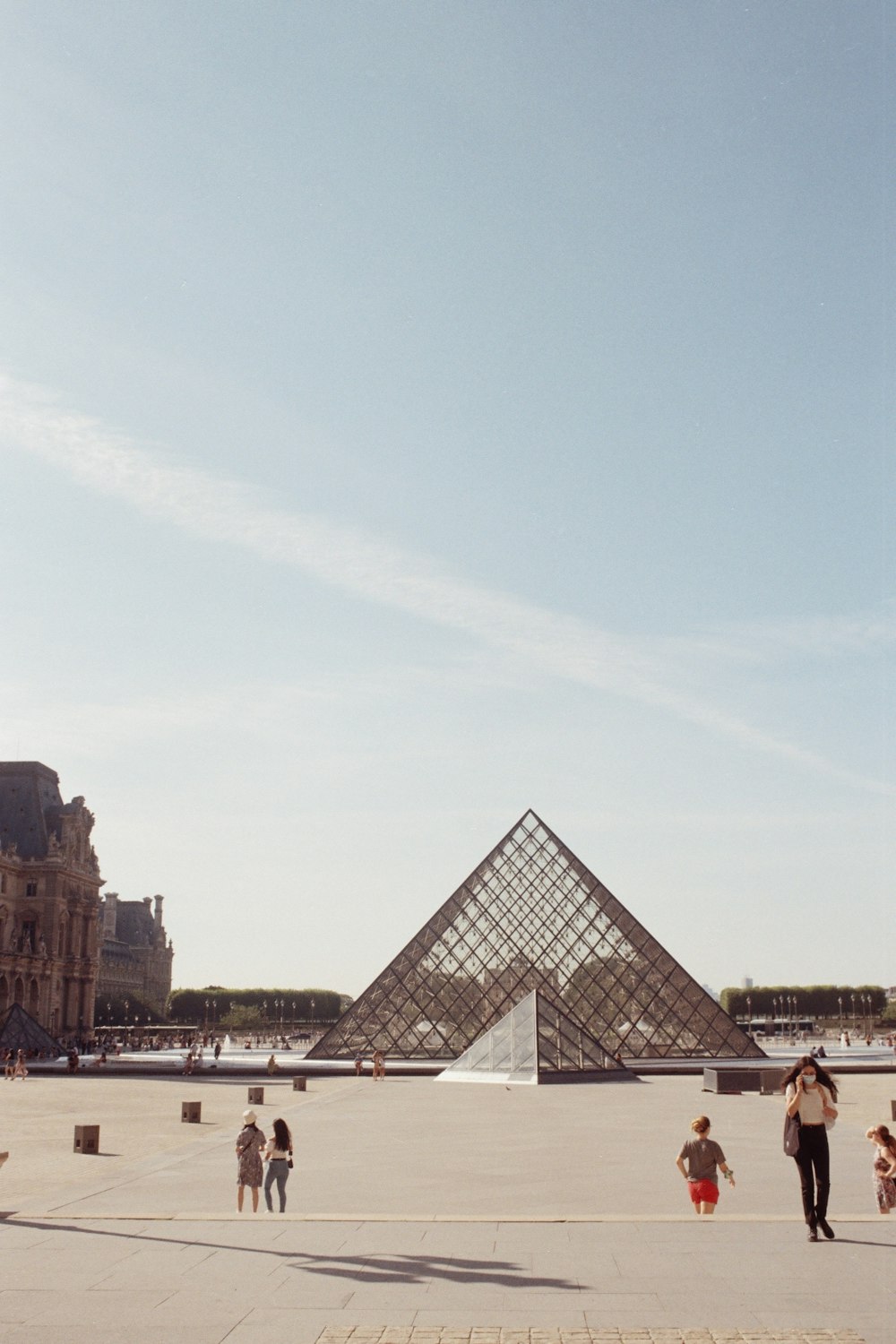 a group of people standing in front of a pyramid