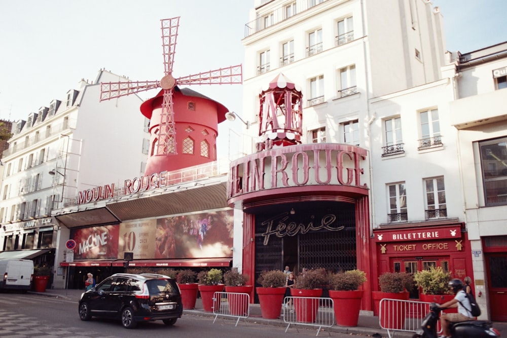 a red building with a windmill on top of it