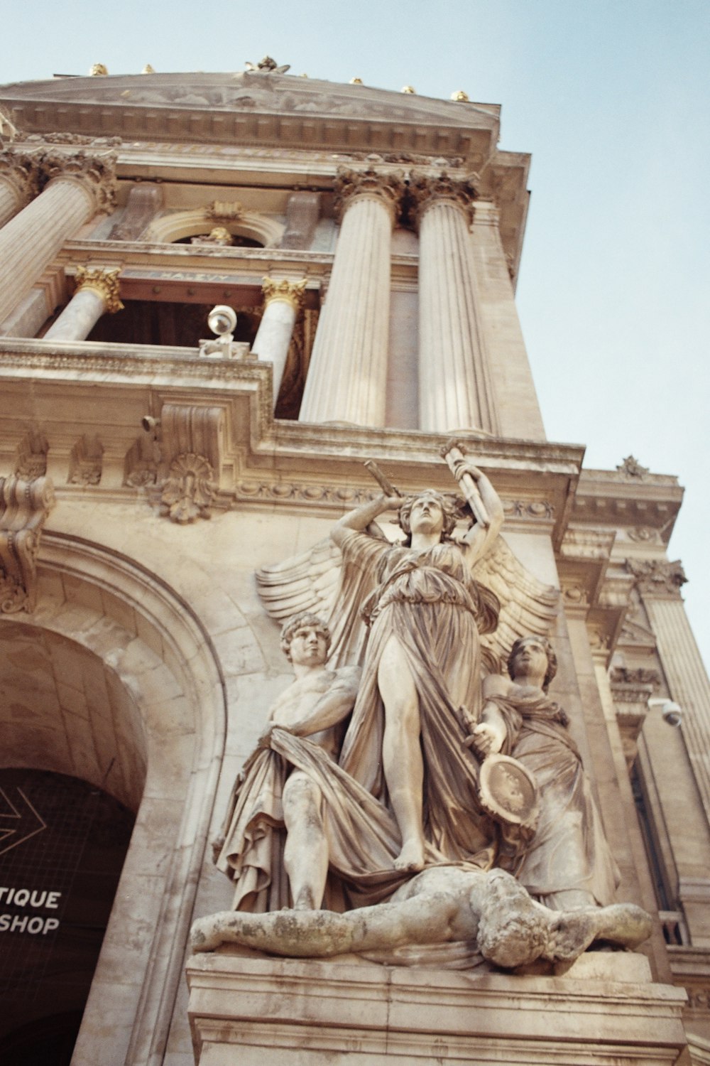 a tall building with a statue on top of it