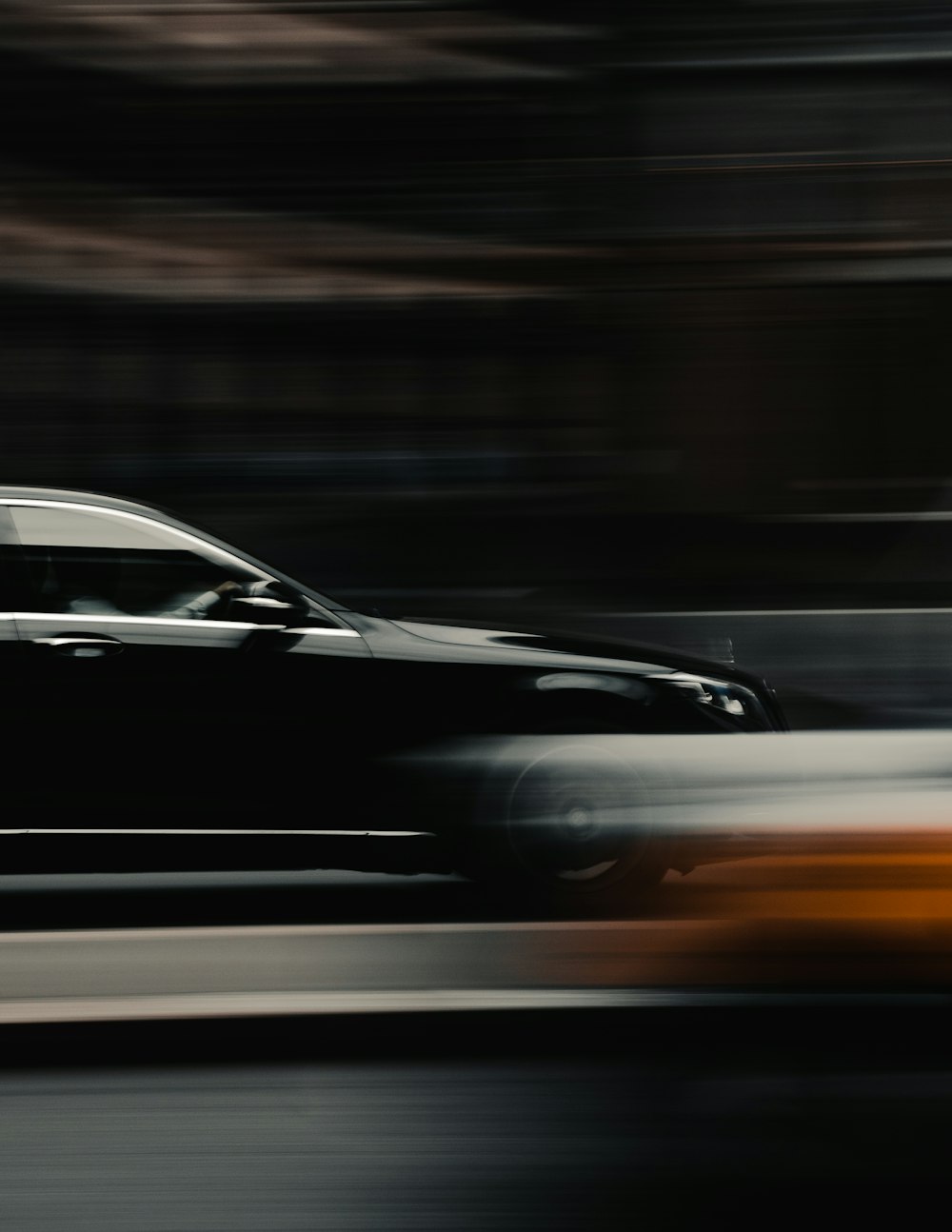 a blurry photo of a car driving down a street