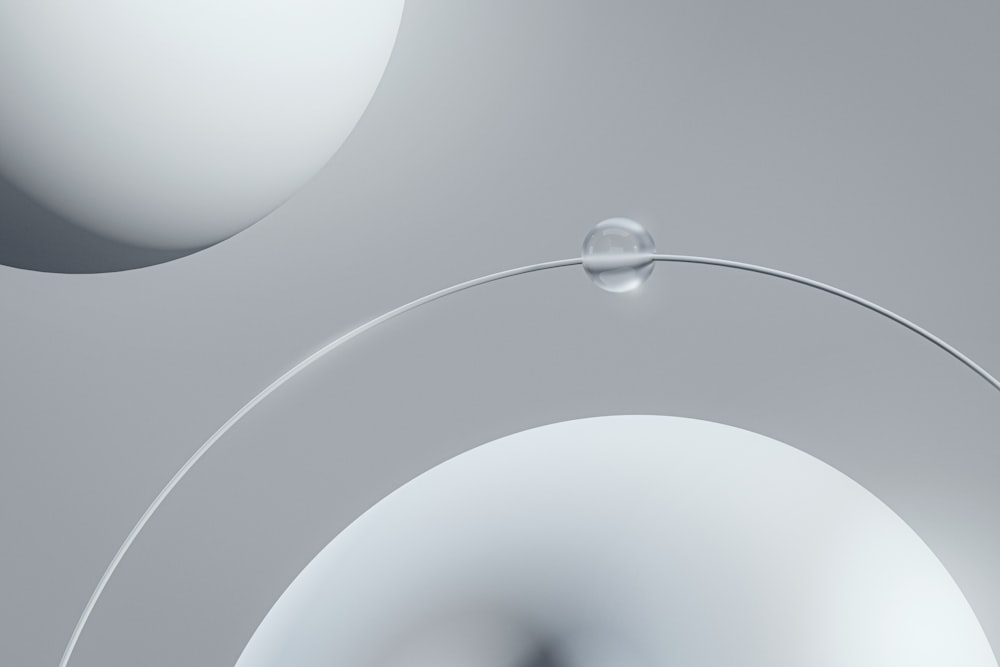 a close up of a white object with a drop of water on it