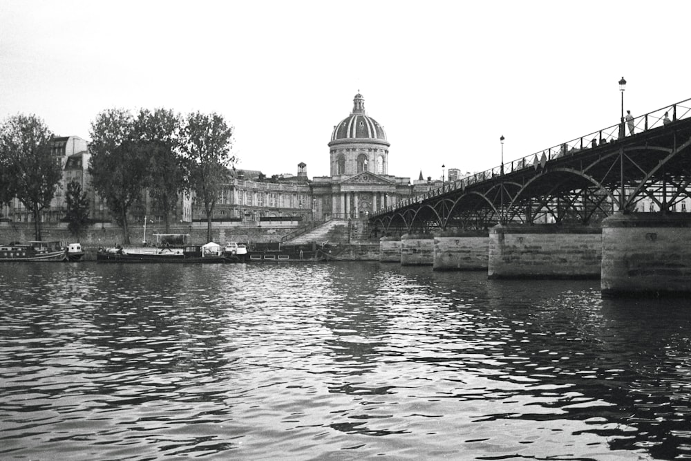 a black and white photo of a bridge over a river