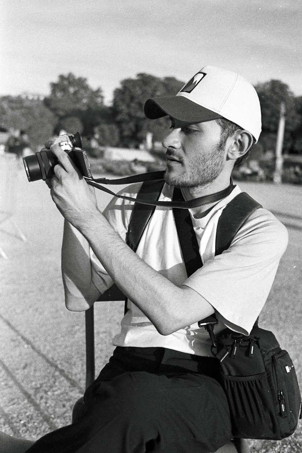 a black and white photo of a man with a camera