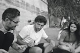 A candid moment of people interacting at an outdoor event.