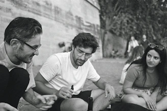 Citizens engaged in a friendly conversation outdoors, smiling and listening.