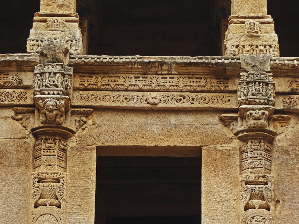 a close up of a doorway with carvings on it