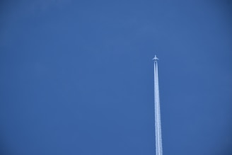 an airplane is flying high in the sky