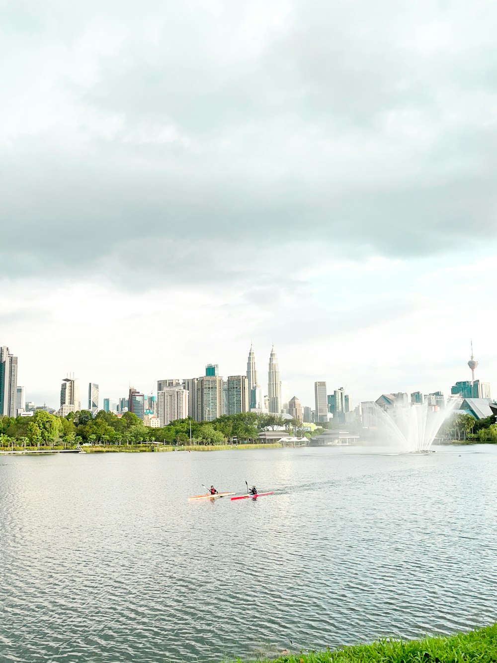 a couple of people riding on top of a boat in a lake