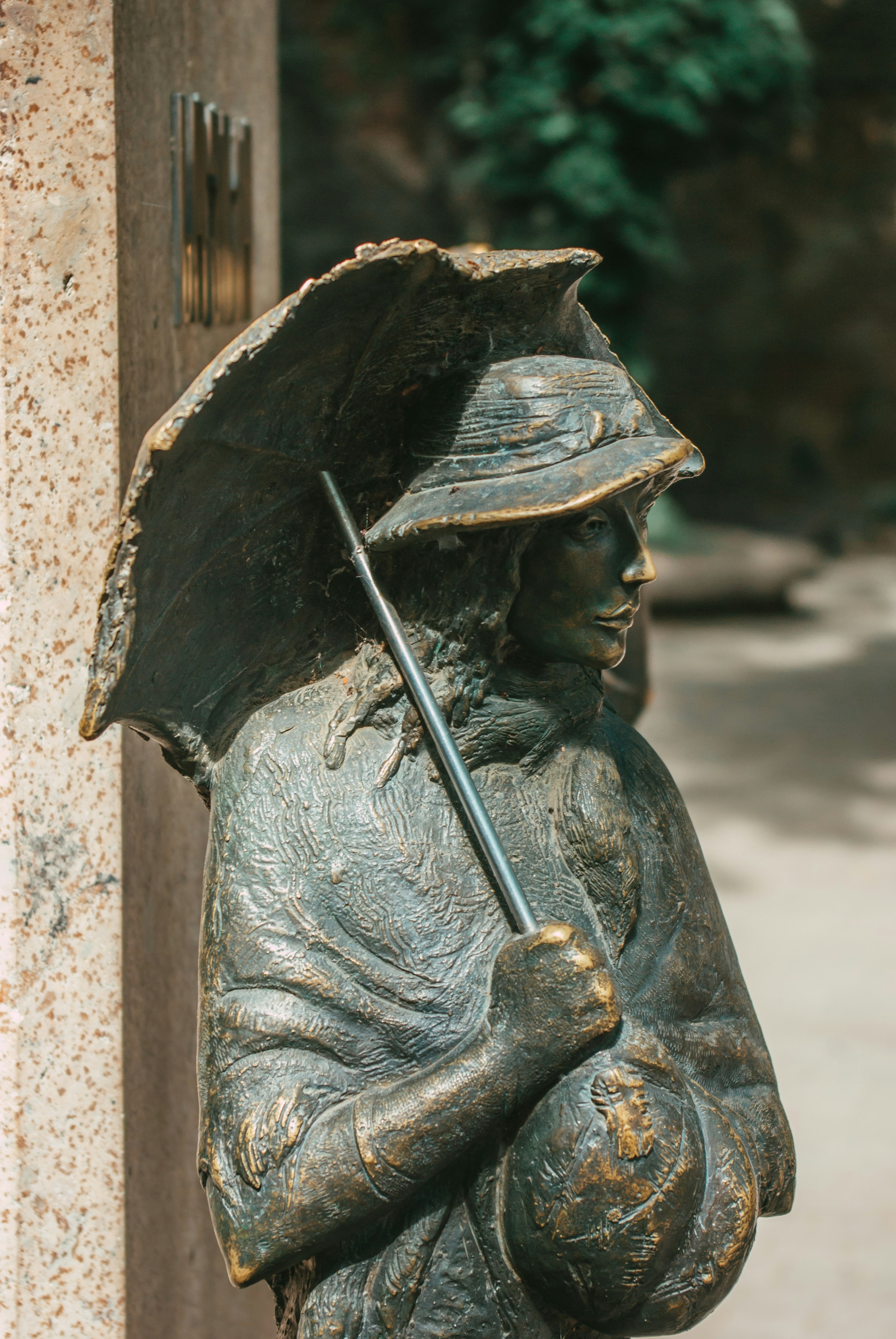 a statue of a man holding an umbrella
