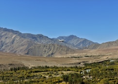 a plane is flying over a mountain range