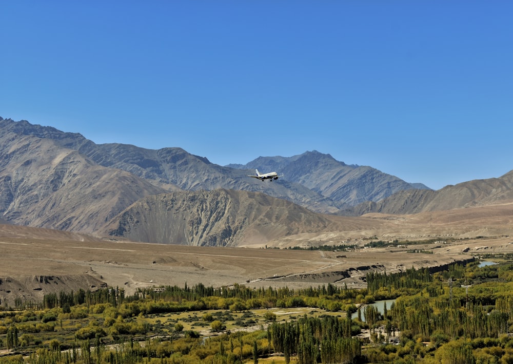 a plane is flying over a mountain range