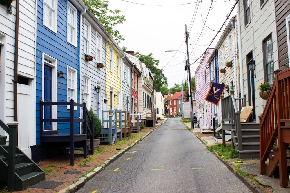 a street lined with multicolored houses in a neighborhood