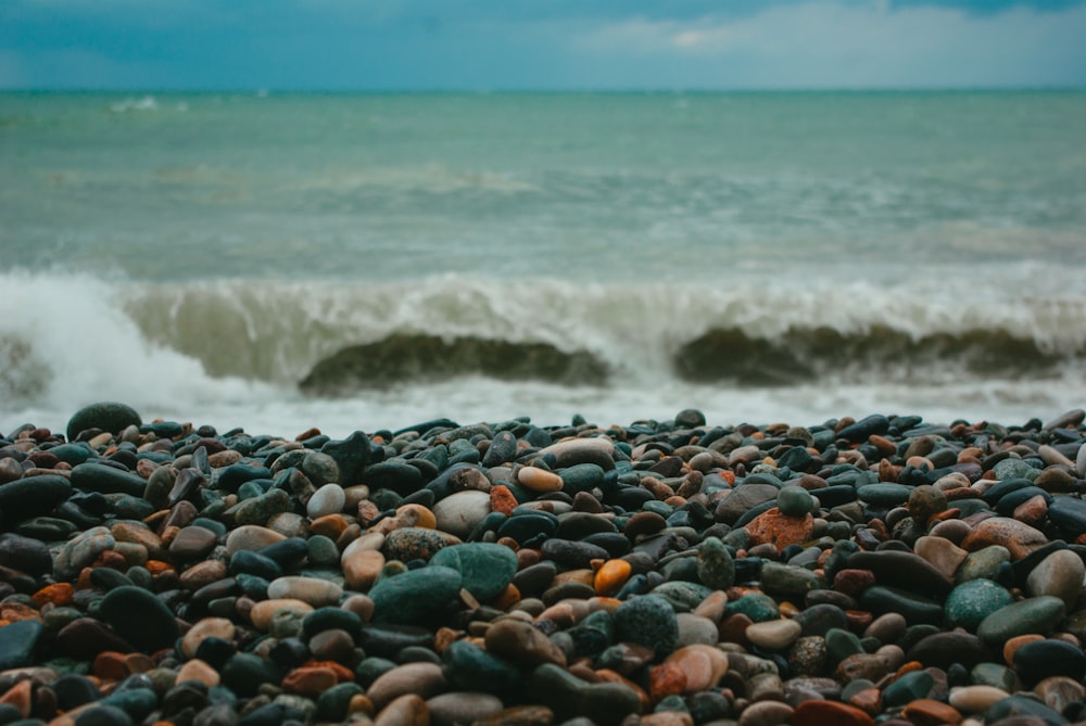 a bunch of rocks on a beach near the ocean