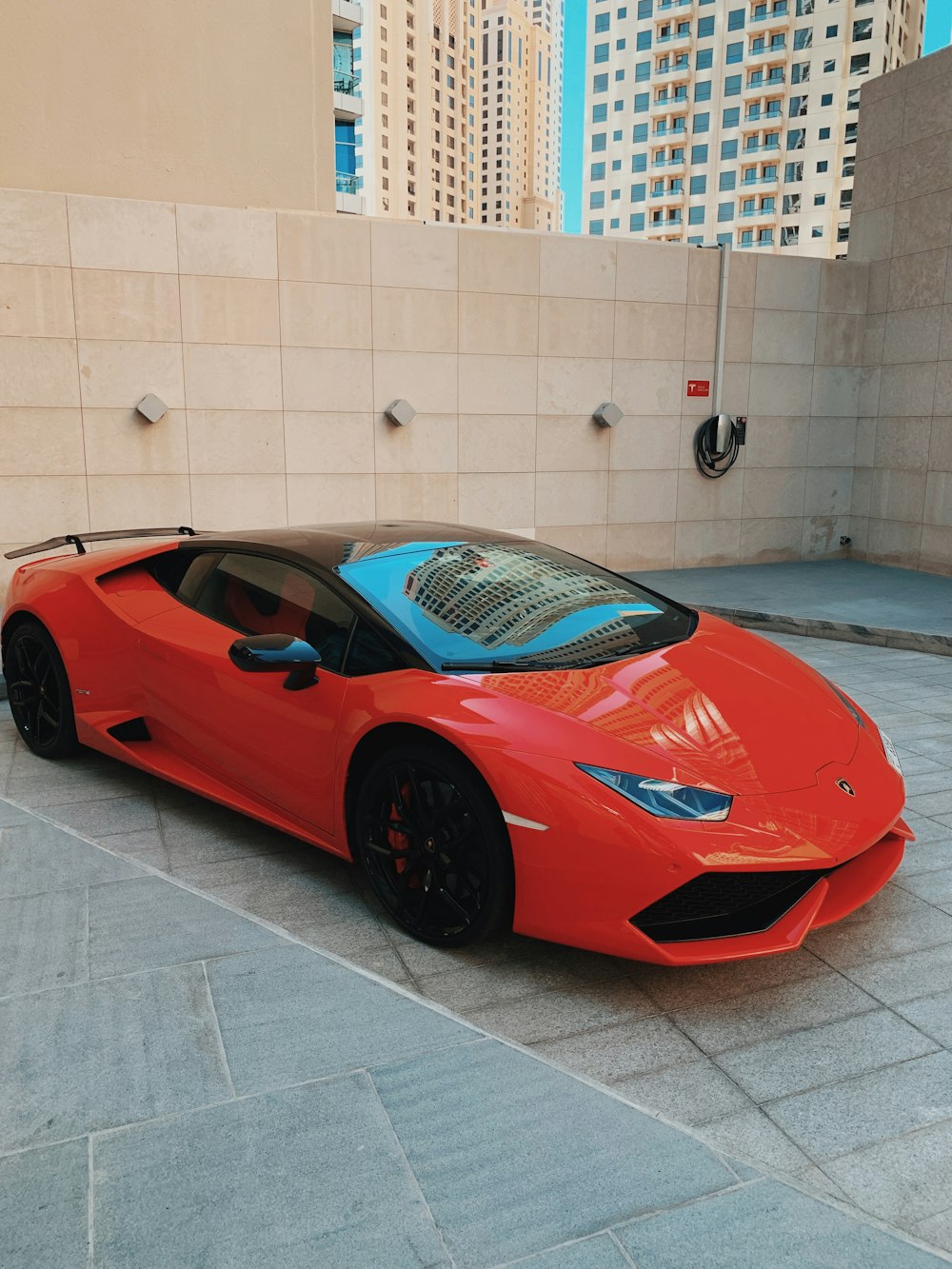 a red sports car parked in front of a building