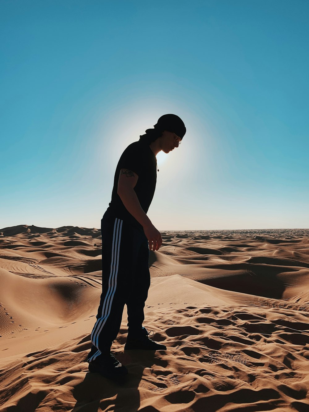 a man standing in the middle of a desert