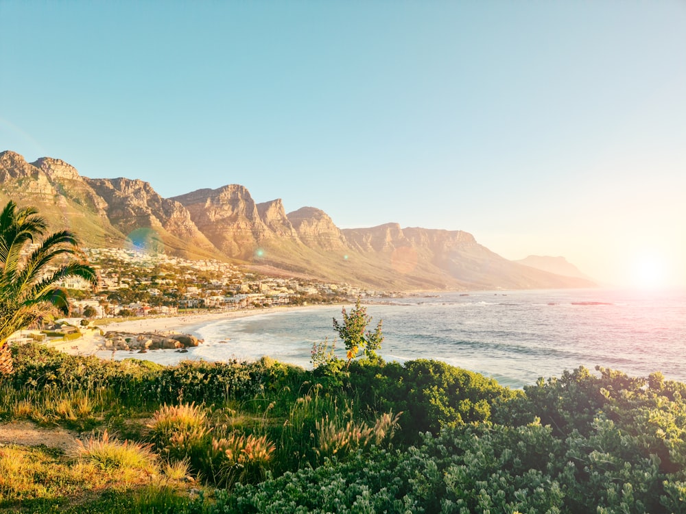 a scenic view of a beach with mountains in the background