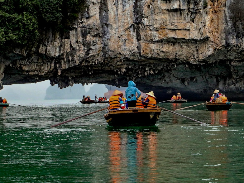 Ha Long Bay's Limestone Karsts a group of people in small boats in a body of water