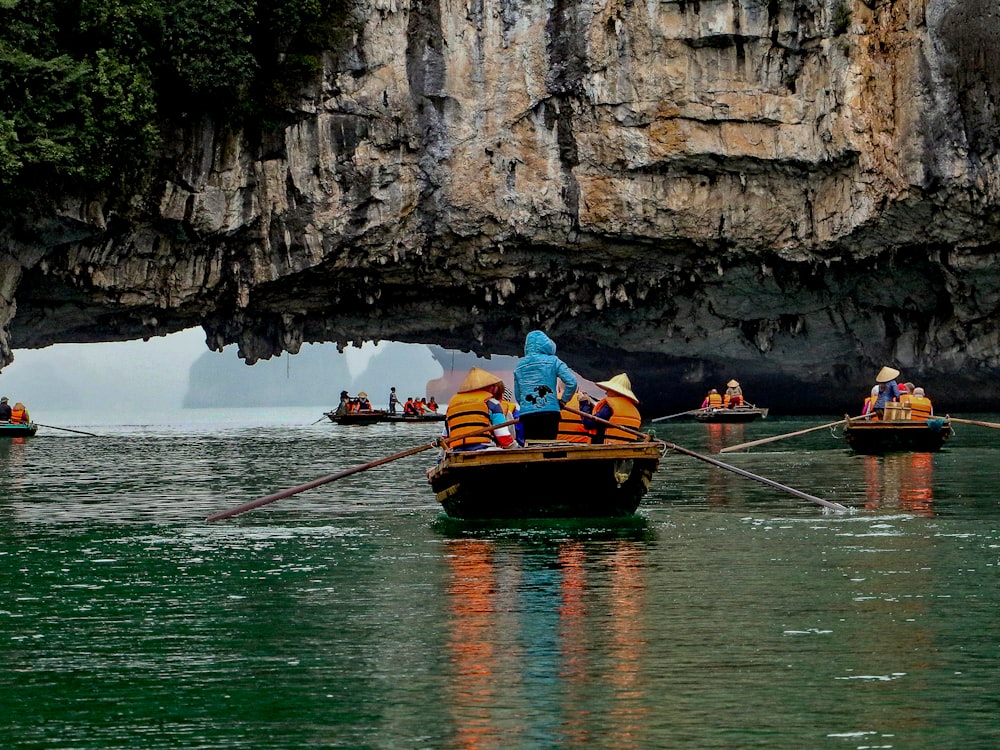 a group of people in small boats in a body of water