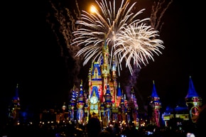 a castle is lit up with fireworks at night