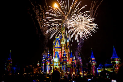 a castle is lit up with fireworks at night