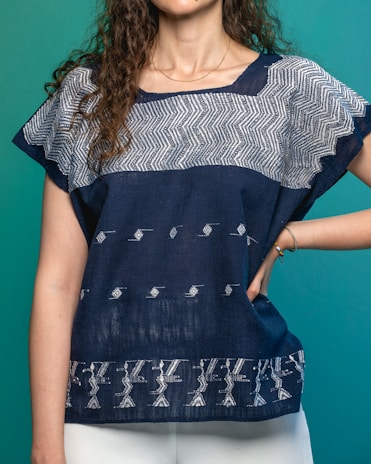 a woman in white pants and a blue top