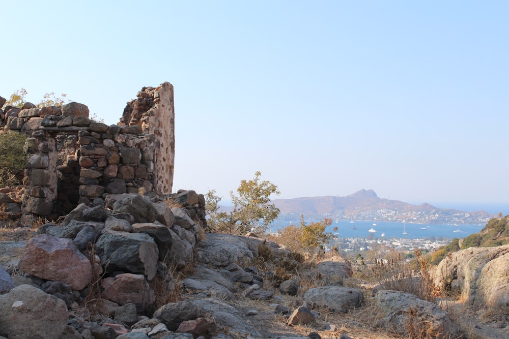 a stone structure with a view of a city in the distance