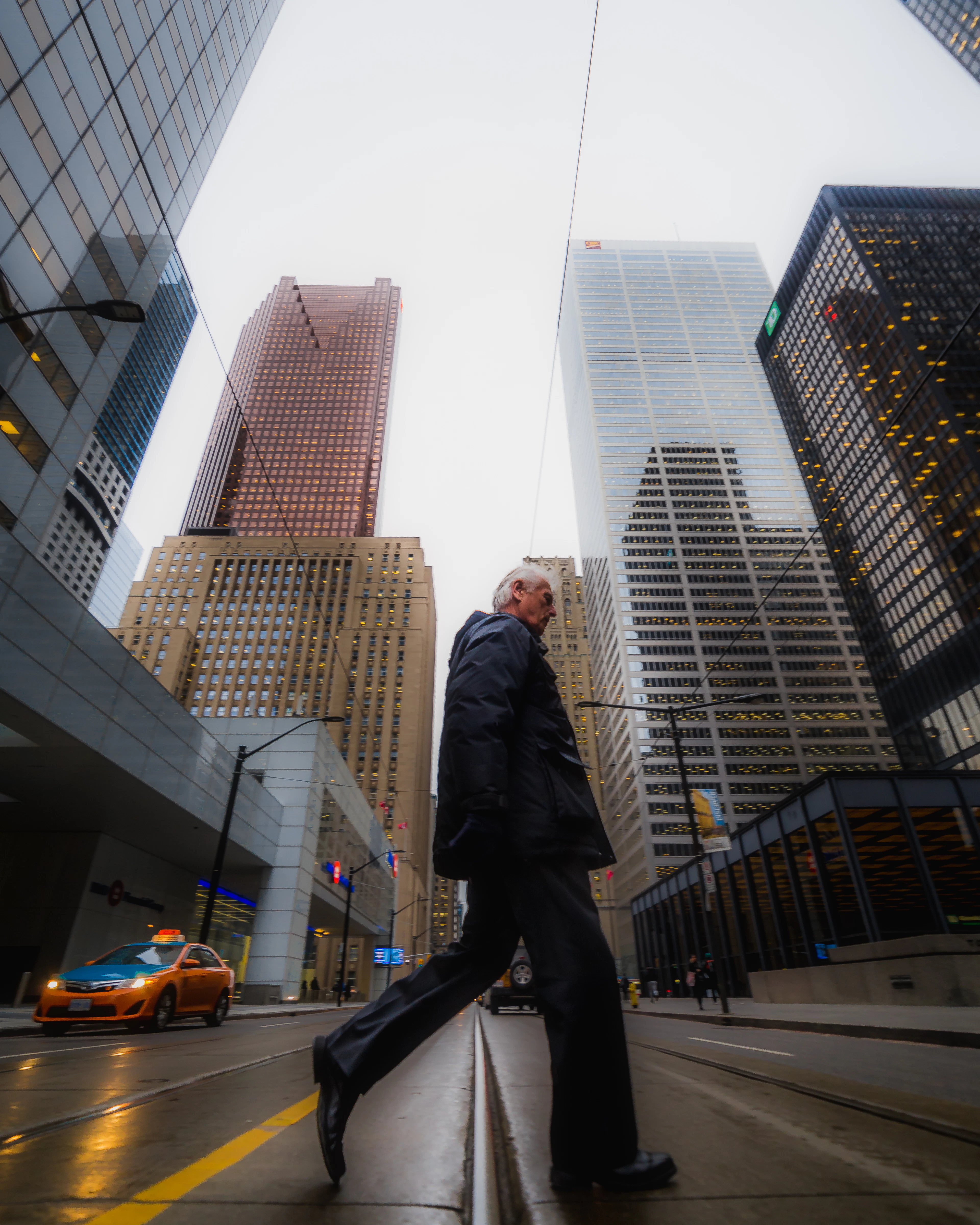 Homme en costume traversant une rue du quartier des affaires de Toronto