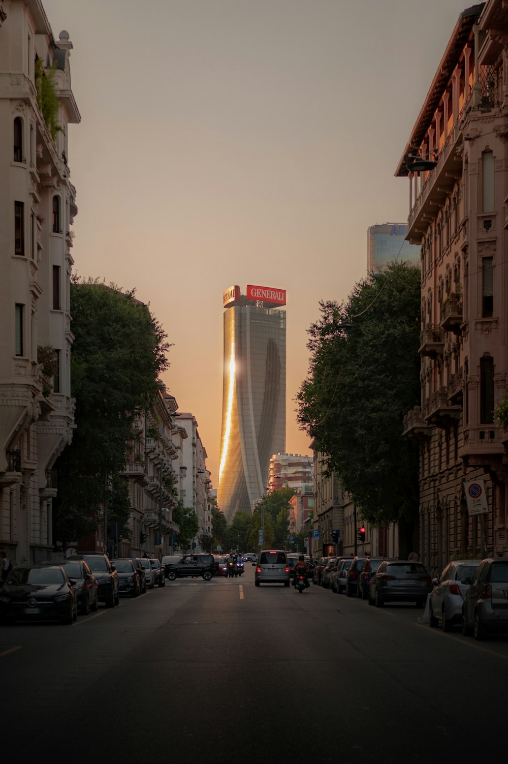 a city street lined with tall buildings and parked cars