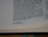 The image shows a close-up of a page from a book, specifically a biblical text. The text discusses Solomon accumulating chariots and horses. There are footnotes at the bottom of the page detailing additional information.