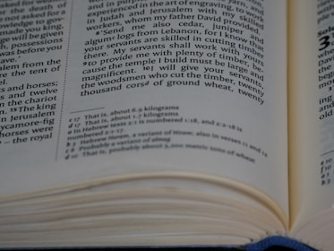 A close-up view of an open book with text written in English. The focus is on the middle to bottom part of the page, displaying a passage with numbers related to weight measurements. The page is slightly curved, indicating the book is partially open.