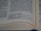 A close-up view of an open book with text written in English. The focus is on the middle to bottom part of the page, displaying a passage with numbers related to weight measurements. The page is slightly curved, indicating the book is partially open.