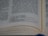 A close-up view of an open book with text written in English. The focus is on the middle to bottom part of the page, displaying a passage with numbers related to weight measurements. The page is slightly curved, indicating the book is partially open.