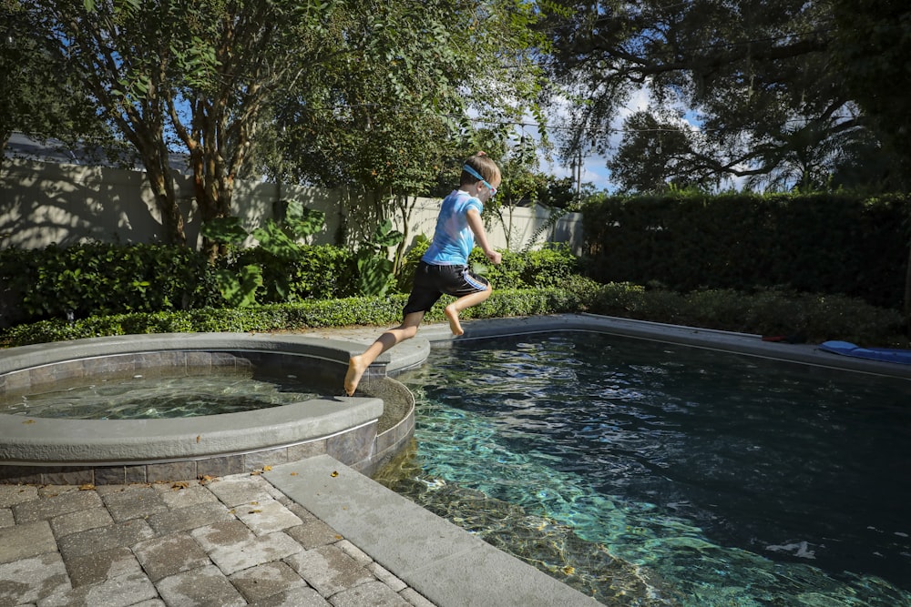 a person jumping into a pool of water